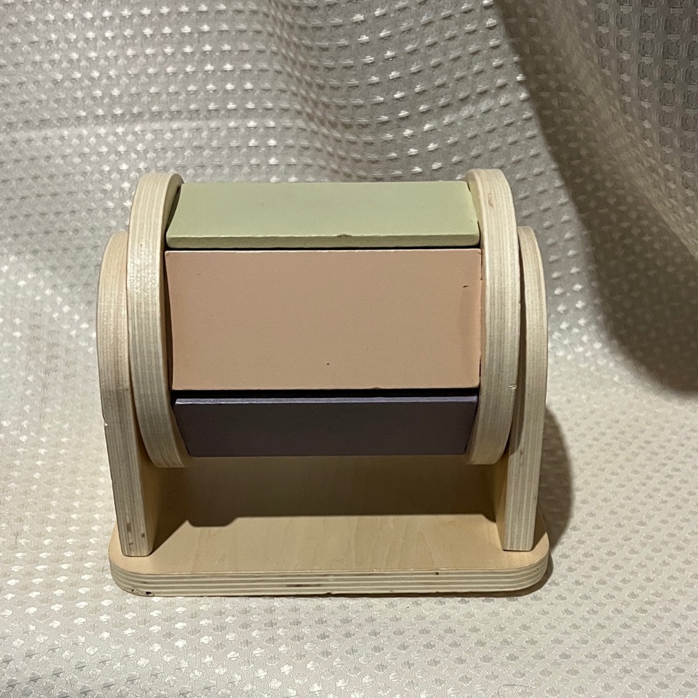 Wooden Montessori spinning drum designed for infant sensory development